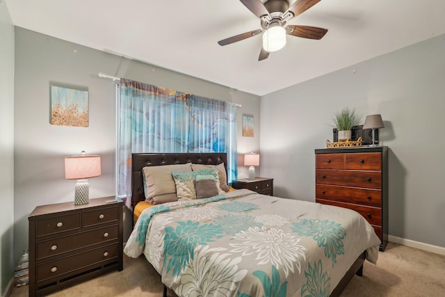 carpeted bedroom with ceiling fan and baseboards