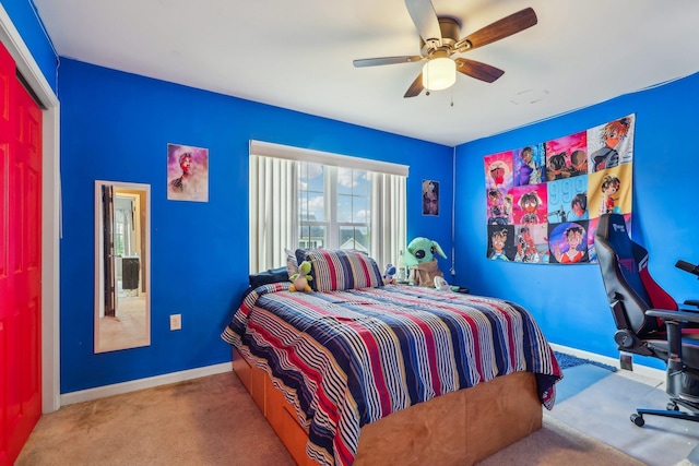 carpeted bedroom featuring baseboards and ceiling fan