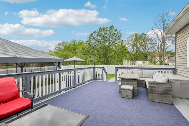 view of patio / terrace with an outdoor living space, a gazebo, a fenced backyard, and a wooden deck
