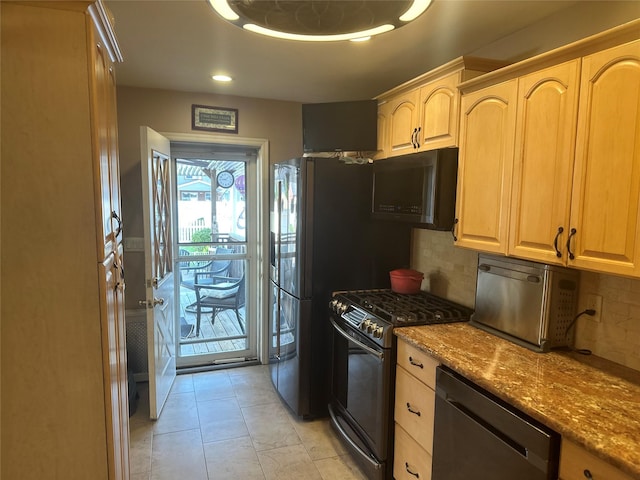 kitchen with black microwave, dishwasher, dark stone countertops, backsplash, and gas range oven