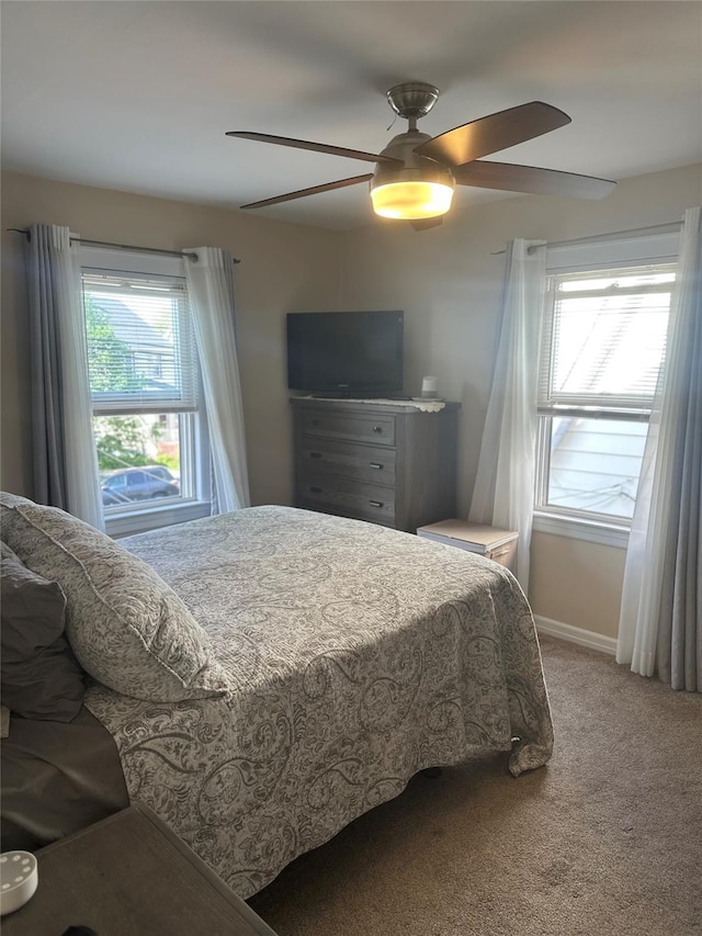 bedroom featuring carpet floors, a ceiling fan, and baseboards