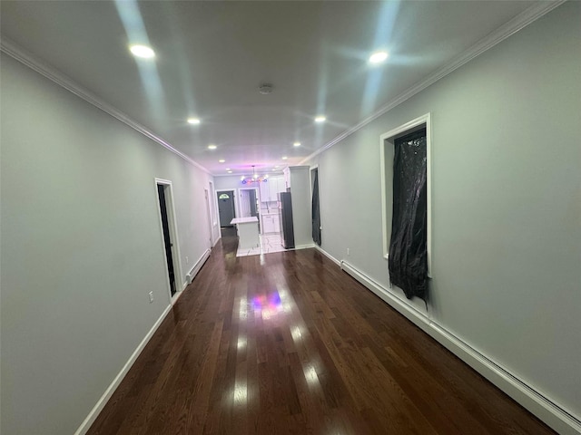 23-21 98th St, Flushing, NY 11369 - hall with recessed lighting, dark wood-style floors, ornamental molding, baseboards, and a baseboard heating unit