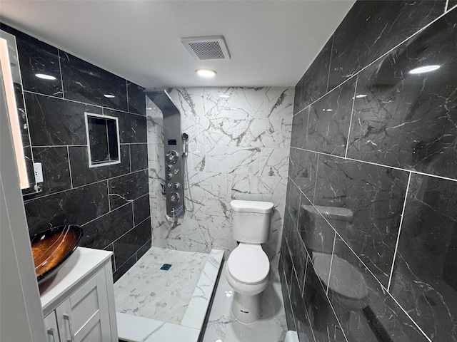 23-21 98th St, Flushing, NY 11369 - bathroom with tile walls, toilet, vanity, tiled shower, and marble finish flooring