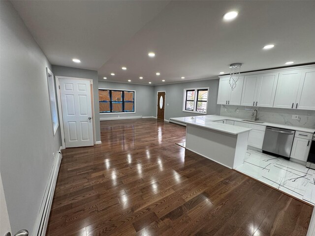 23-21 98th St, Flushing, NY 11369 - kitchen with stainless steel dishwasher, a sink, a baseboard heating unit, recessed lighting, and baseboards