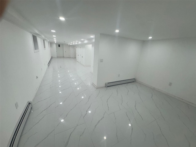 23-21 98th St, Flushing, NY 11369 - below grade area with baseboard heating, light marble finish flooring, recessed lighting, baseboards, and a baseboard heating unit