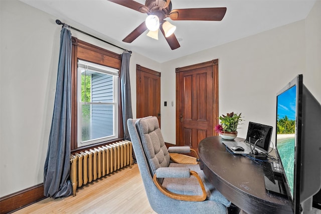 96 E Main St, Port Jervis, NY 12771 - home office featuring radiator, light wood-style flooring, and ceiling fan