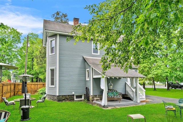 96 E Main St, Port Jervis, NY 12771 - back of property featuring a shingled roof, a chimney, and a patio area