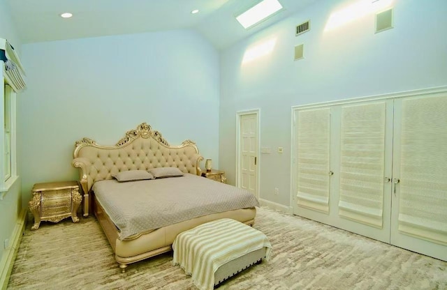 bedroom featuring high vaulted ceiling, baseboards, and visible vents