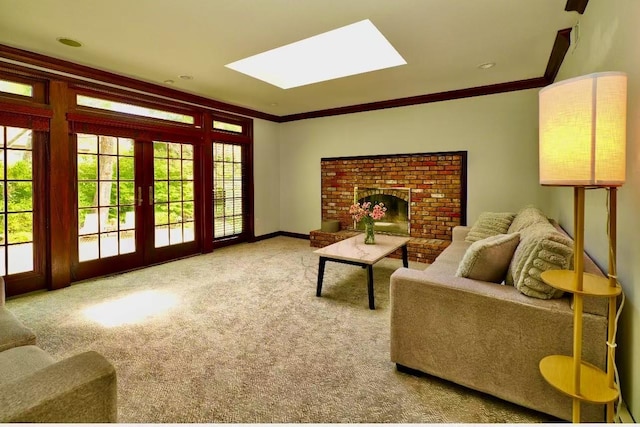 living room with french doors, a skylight, crown molding, a fireplace, and carpet floors