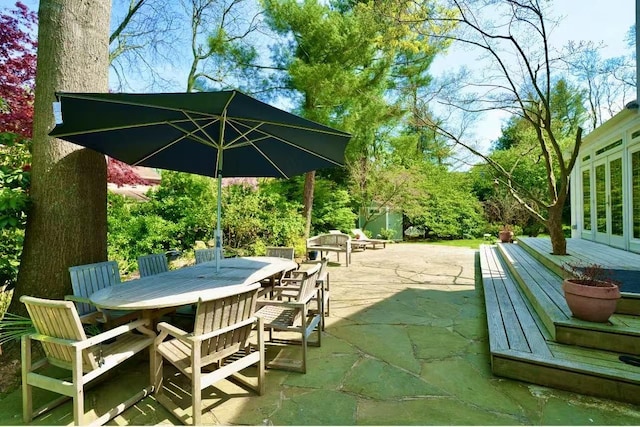 view of patio / terrace with a wooden deck and outdoor dining area