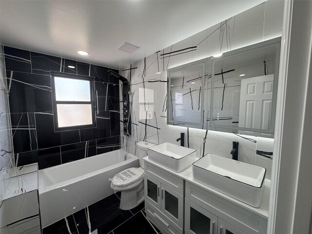 527 E 5th St, Brooklyn, NY 11218 - full bathroom featuring a sink, toilet, tile walls, washtub / shower combination, and double vanity