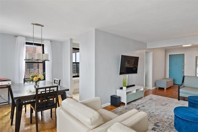living area with radiator heating unit and baseboards