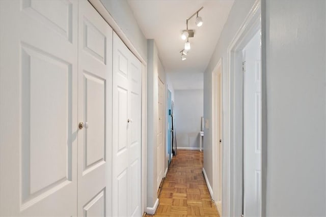 hall featuring baseboards