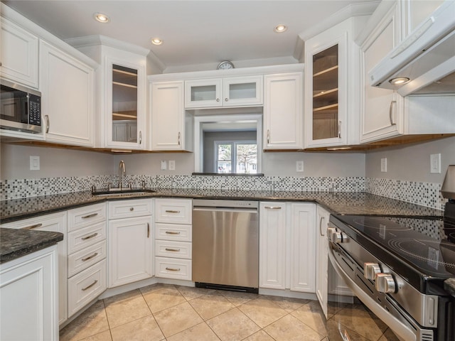 kitchen featuring a sink, under cabinet range hood, white cabinets, and appliances with stainless steel finishes