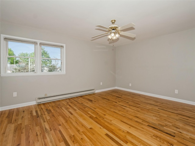 empty room with baseboards, light wood-type flooring, and baseboard heating