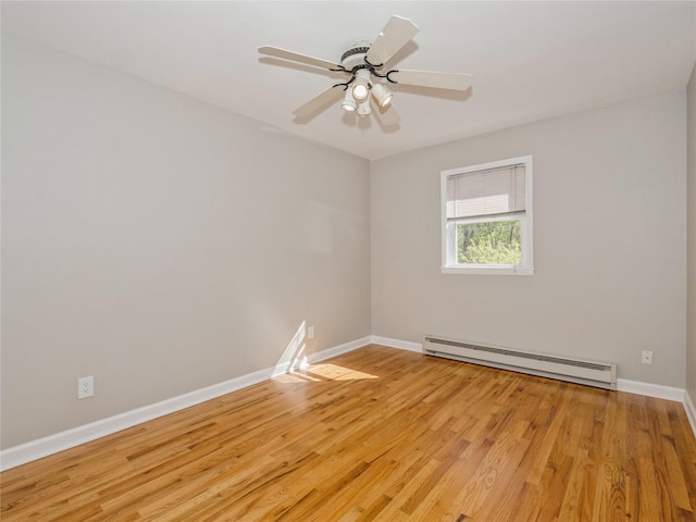 empty room featuring light wood-style flooring, baseboards, and baseboard heating