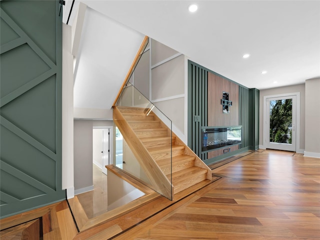 5 N Hills Rd, East Norwich, NY 11732 - stairs with a fireplace, recessed lighting, wood finished floors, and baseboards