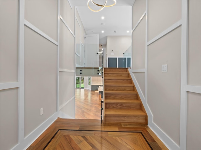 5 N Hills Rd, East Norwich, NY 11732 - stairs featuring recessed lighting, baseboards, and parquet flooring