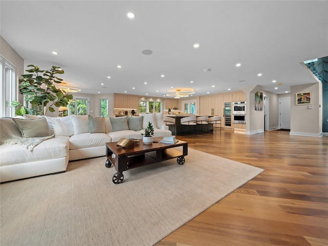 5 N Hills Rd, East Norwich, NY 11732 - living area with recessed lighting, light wood-type flooring, baseboards, and a chandelier