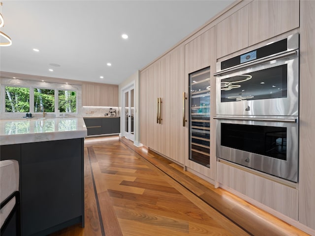 5 N Hills Rd, East Norwich, NY 11732 - kitchen featuring double oven, modern cabinets, light wood-type flooring, decorative backsplash, and light brown cabinetry