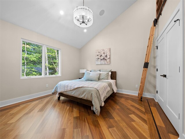 5 N Hills Rd, East Norwich, NY 11732 - bedroom with a chandelier, baseboards, dark wood finished floors, and high vaulted ceiling