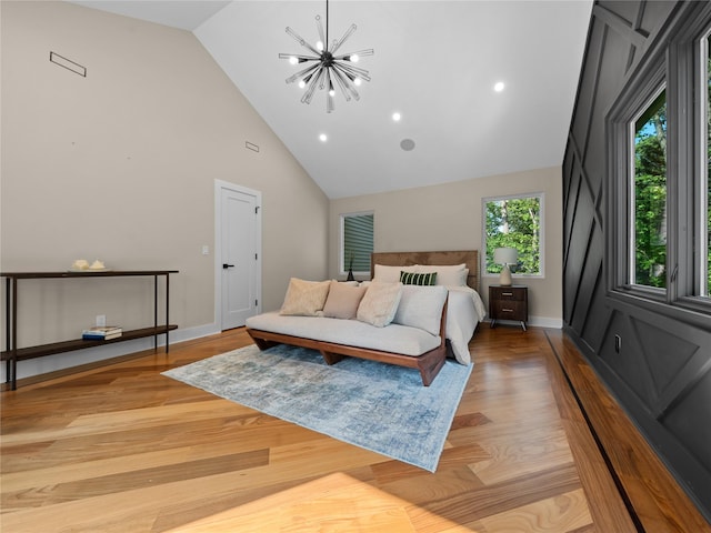 5 N Hills Rd, East Norwich, NY 11732 - bedroom featuring a chandelier, high vaulted ceiling, light wood-style floors, and baseboards