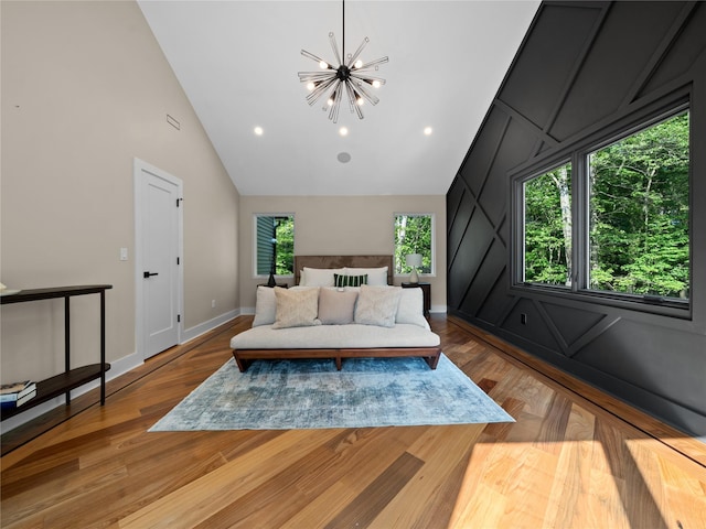 5 N Hills Rd, East Norwich, NY 11732 - bedroom with a chandelier, high vaulted ceiling, wood finished floors, baseboards, and a decorative wall
