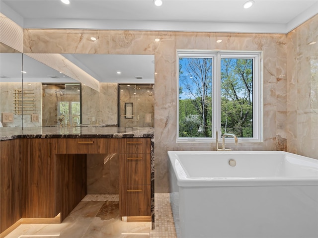 5 N Hills Rd, East Norwich, NY 11732 - bathroom featuring a soaking tub, vanity, recessed lighting, marble finish floors, and tile walls