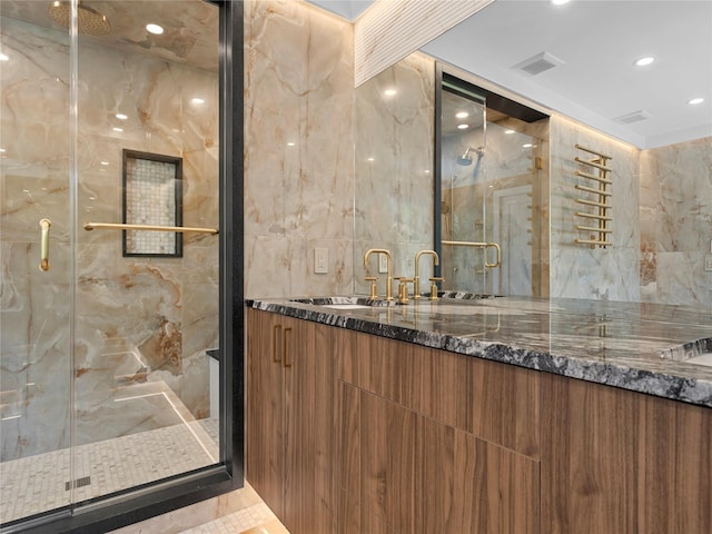 5 N Hills Rd, East Norwich, NY 11732 - full bathroom featuring a marble finish shower, double vanity, tile walls, and recessed lighting