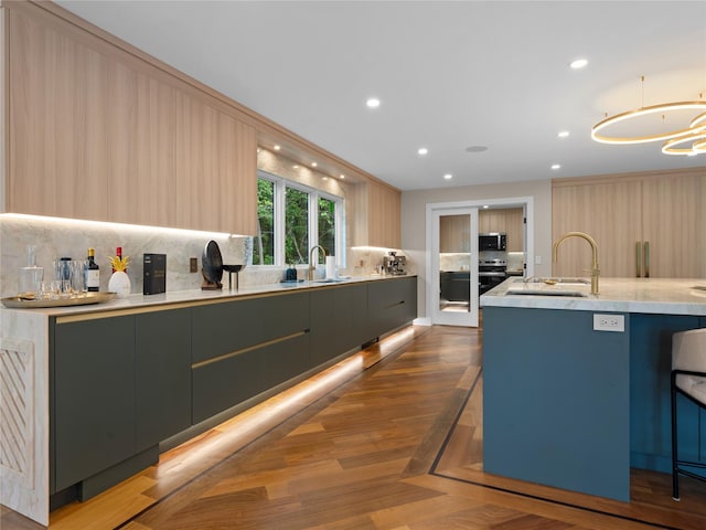 5 N Hills Rd, East Norwich, NY 11732 - kitchen with modern cabinets, backsplash, a sink, stainless steel microwave, and recessed lighting