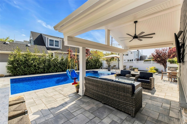 view of patio / terrace featuring a fenced backyard, an outdoor living space, a ceiling fan, and a fenced in pool