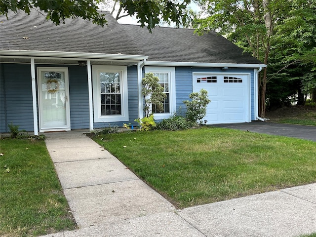 140A Laurance Ln, Ridge, NY 11961 - view of front of house with an attached garage, a shingled roof, asphalt driveway, a front lawn, and a porch