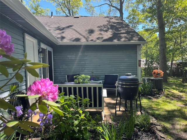 140A Laurance Ln, Ridge, NY 11961 - exterior view of a shingled roof, central AC, a downspout, and gutters