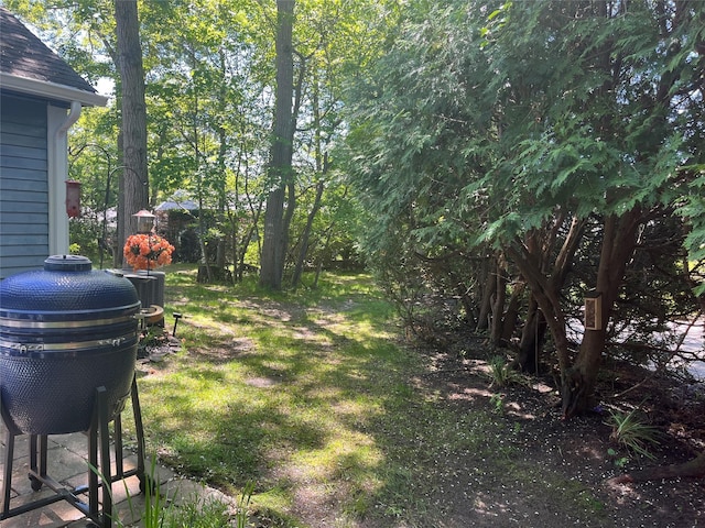 140A Laurance Ln, Ridge, NY 11961 - view of green lawn featuring central AC unit