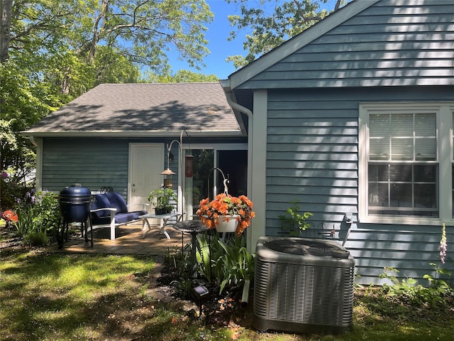 140A Laurance Ln, Ridge, NY 11961 - rear view of house with central air condition unit and a patio