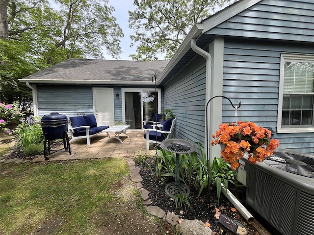 140A Laurance Ln, Ridge, NY 11961 - back of property with a patio area and central AC