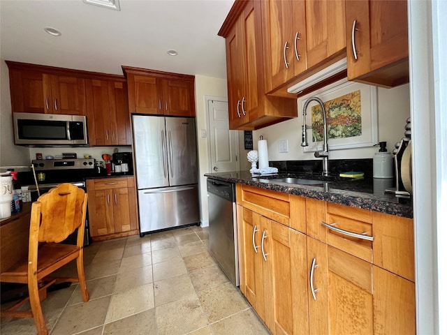 140A Laurance Ln, Ridge, NY 11961 - kitchen with stainless steel appliances, a sink, brown cabinets, dark stone counters, and recessed lighting