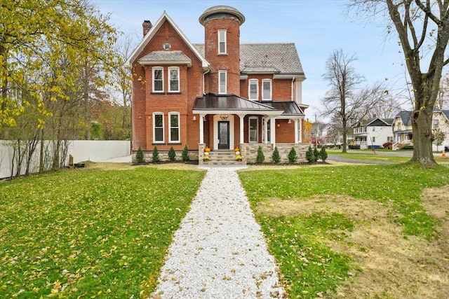 260 Main St, Goshen, NY 10924 - victorian home with a chimney, brick siding, a front lawn, and fence