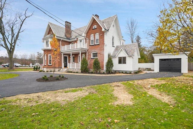 260 Main St, Goshen, NY 10924 - traditional-style home with a porch, aphalt driveway, an outdoor structure, brick siding, and a balcony