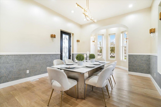 260 Main St, Goshen, NY 10924 - dining space featuring wood finished floors, a wainscoted wall, visible vents, arched walkways, and recessed lighting