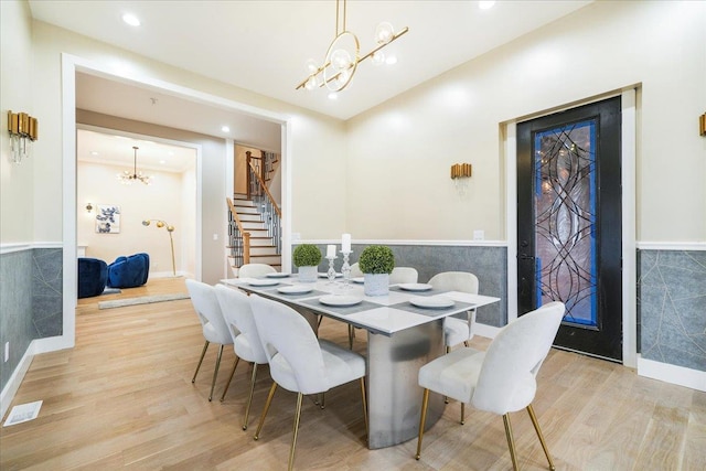 260 Main St, Goshen, NY 10924 - dining room featuring an inviting chandelier, visible vents, a wainscoted wall, wood finished floors, and stairway