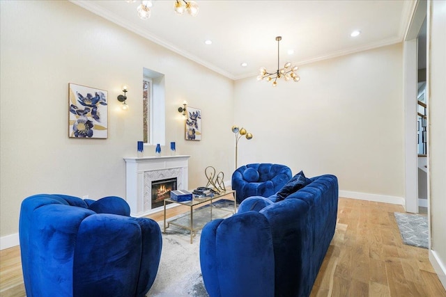 260 Main St, Goshen, NY 10924 - living area featuring light wood-style flooring, a fireplace, baseboards, a chandelier, and ornamental molding