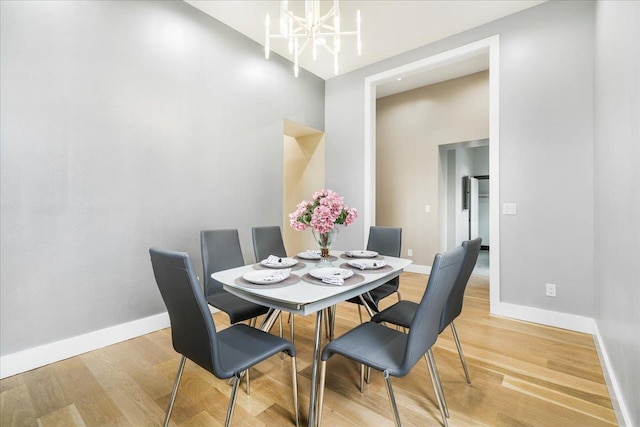 260 Main St, Goshen, NY 10924 - dining space with baseboards, a chandelier, and wood finished floors