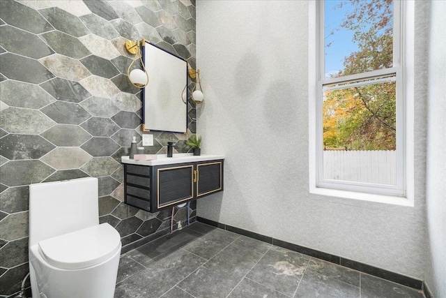 260 Main St, Goshen, NY 10924 - bathroom featuring baseboards, a wood stove, vanity, and toilet