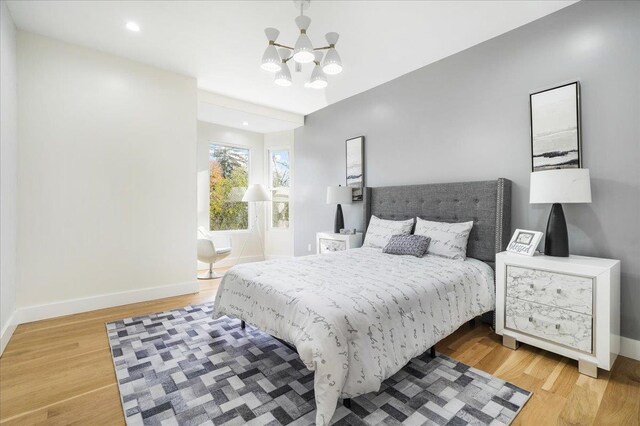 260 Main St, Goshen, NY 10924 - bedroom featuring an inviting chandelier, light wood-style floors, and baseboards