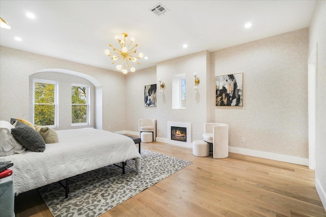260 Main St, Goshen, NY 10924 - bedroom with wood finished floors, baseboards, visible vents, recessed lighting, and a notable chandelier