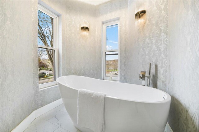 260 Main St, Goshen, NY 10924 - bathroom featuring a freestanding bath, baseboards, marble finish floor, and wallpapered walls