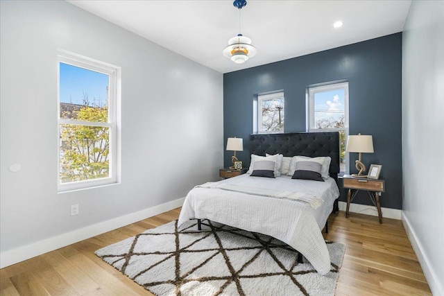 260 Main St, Goshen, NY 10924 - bedroom featuring baseboards, multiple windows, and light wood-type flooring