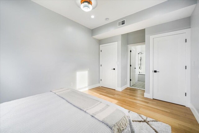 260 Main St, Goshen, NY 10924 - unfurnished bedroom with ensuite bathroom, light wood-style flooring, baseboards, and visible vents