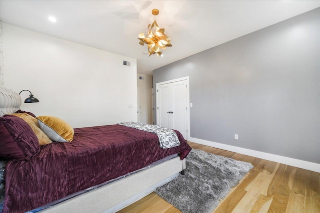260 Main St, Goshen, NY 10924 - bedroom with baseboards, a chandelier, visible vents, and wood finished floors